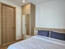 Modern bedroom with wooden furniture and a neatly made bed