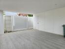 Spacious and clean garage with tiled floor and large sliding door