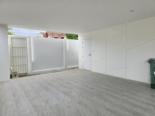 Spacious and clean garage with tiled floor and large sliding door