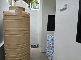 Outdoor utility area with water tank and storage