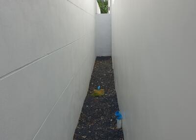 Narrow passage between white walls