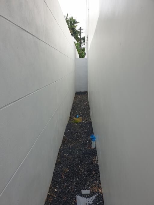 Narrow passage between white walls