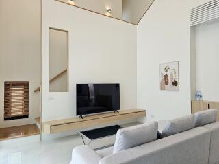 Modern living room with minimalistic decor and a flat screen TV