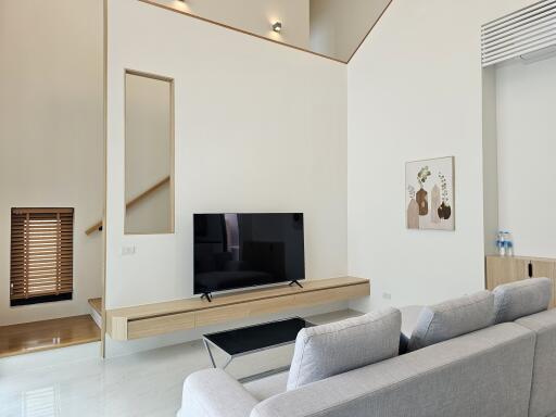 Modern living room with minimalistic decor and a flat screen TV