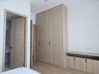 Bedroom with built-in wardrobe and door to bathroom