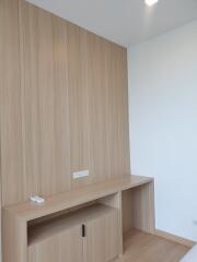 Minimalistic wooden desk in a bedroom against wooden paneled wall