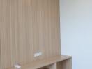 Minimalistic wooden desk in a bedroom against wooden paneled wall