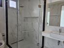 Modern bathroom with walk-in shower and white fixtures