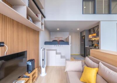 Modern living area with loft bed and open kitchen