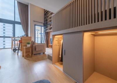 Modern loft-style living area with high ceilings and natural light