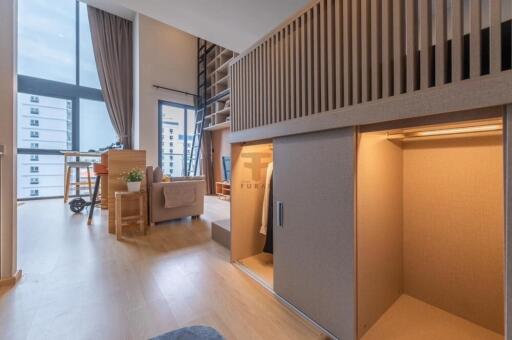 Modern loft-style living area with high ceilings and natural light