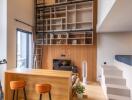 Modern living room with high ceilings, built-in bookshelves, and a loft area