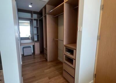 Spacious walk-in closet with built-in shelves and drawers
