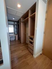 Spacious walk-in closet with built-in shelves and drawers