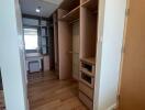 Spacious walk-in closet with built-in shelves and drawers