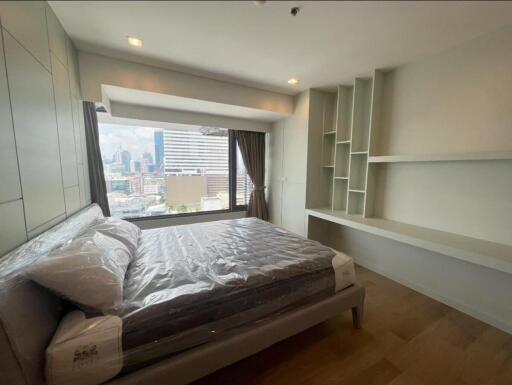 Modern bedroom with large windows and city view