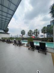 Outdoor swimming pool area with city skyline view