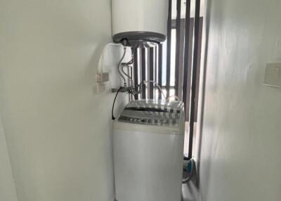 Compact laundry room with washing machine and water heater