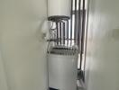 Compact laundry room with washing machine and water heater