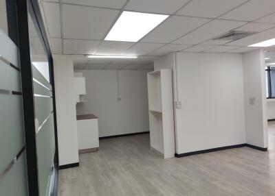 Modern commercial office space with white walls and ceiling lights