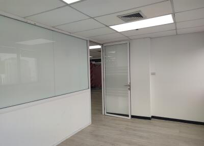 Modern office space with glass door and whiteboard