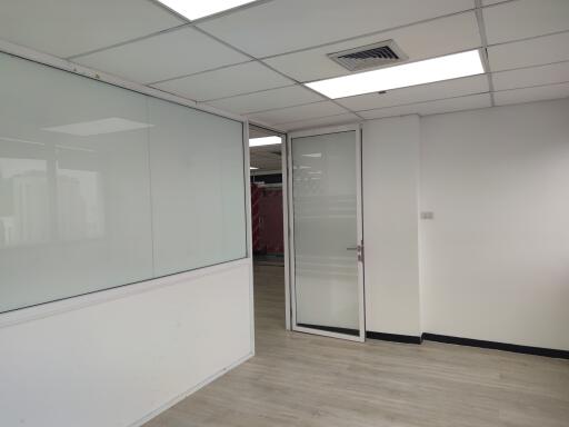 Modern office space with glass door and whiteboard