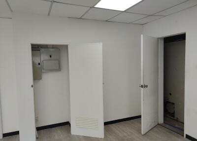 Utility room with open doors and electrical panel