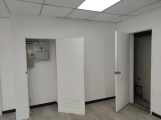 Utility room with open doors and electrical panel