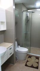 Modern bathroom with glass shower, sink, and toilet