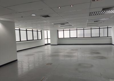 Spacious vacant office area with large windows