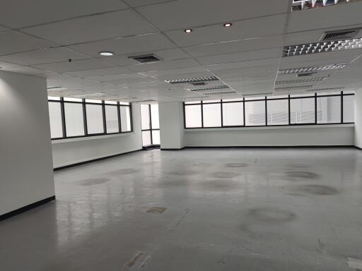 Spacious vacant office area with large windows