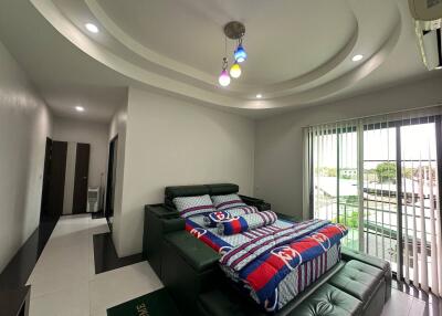 Modern bedroom with colorful bedding and ceiling lights