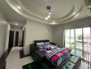 Modern bedroom with colorful bedding and ceiling lights