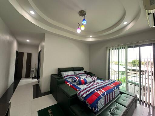 Modern bedroom with colorful bedding and ceiling lights