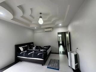 Spacious bedroom with a modern ceiling design