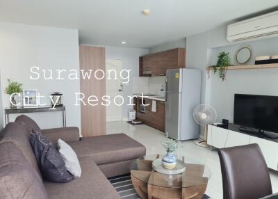 Modern living space with kitchen and dining area in Surawong City Resort