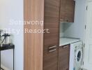 Laundry area with wooden cabinets and washing machine