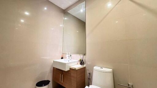 Modern bathroom with sink, mirror, and toilet