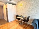 Compact dining area with table and chairs adjacent to kitchen and living space