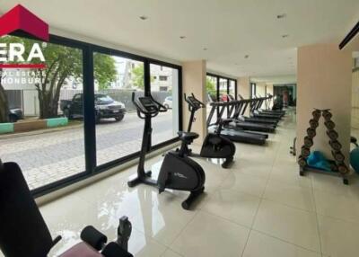 Well-equipped gym with multiple exercise machines and large windows