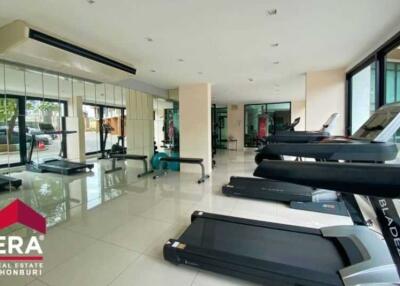 Modern fitness center with treadmills and large windows