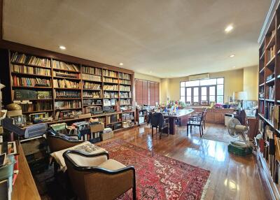 Spacious home office with extensive built-in bookshelves