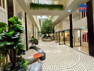 Modern building interior with plants and seating areas