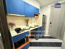 Modern compact kitchen with blue cabinetry