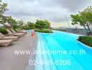 Swimming pool area with lounge chairs and trees