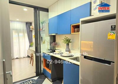 Modern kitchen with integrated appliances and adjacent living area