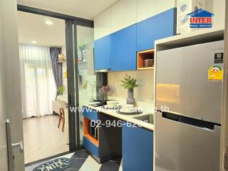 Modern kitchen with integrated appliances and adjacent living area