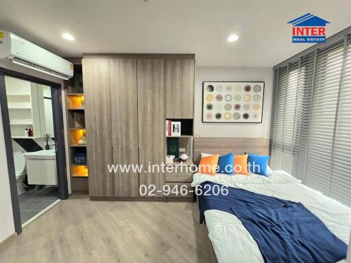 Modern bedroom with wooden floor, large wardrobe, and decorations