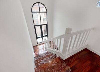 Indoor staircase with wooden steps and white railing