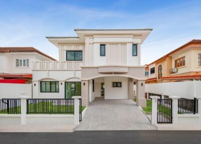 Modern two-story house exterior with gated driveway